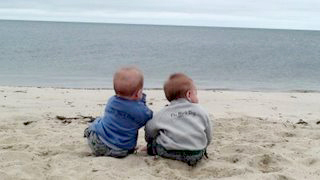 little boys sitting on beach